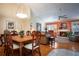 Open concept dining room with hardwood floors, fireplace, and adjacent living room at 3 Escondido Cir # 18, Altamonte Springs, FL 32701