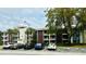 Exterior view of a condo building with parking and landscaping at 3 Escondido Cir # 18, Altamonte Springs, FL 32701