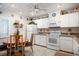 Bright kitchen with white cabinets, appliances, and a breakfast nook at 3 Escondido Cir # 18, Altamonte Springs, FL 32701