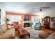 Living room with hardwood floors, fireplace, and ample natural light at 3 Escondido Cir # 18, Altamonte Springs, FL 32701