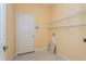 Laundry room with built-in shelving at 8745 Via Bella Notte, Orlando, FL 32836