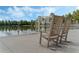 Relaxing lakefront view with wooden rocking chairs at 1020 Siena Park W Blvd # 303, Celebration, FL 34747