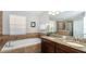 Bathroom features a large soaking tub and double vanity at 1431 Thunderbird Rd, Davenport, FL 33896