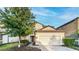 Two-story house with a two-car garage and landscaped front yard at 1431 Thunderbird Rd, Davenport, FL 33896