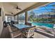 Covered patio with dining table and chairs, overlooking the pool at 1431 Thunderbird Rd, Davenport, FL 33896