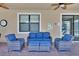 Relaxing patio with wicker furniture and ceiling fans at 1431 Thunderbird Rd, Davenport, FL 33896