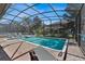 Resort-style pool with screened enclosure and lounge chairs at 1431 Thunderbird Rd, Davenport, FL 33896