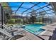 Screened pool and spa with lounge chairs at 1431 Thunderbird Rd, Davenport, FL 33896