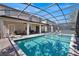 Inviting pool area with screened enclosure, patio furniture, and a spa at 1431 Thunderbird Rd, Davenport, FL 33896