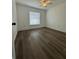 Bright bedroom with vinyl plank flooring and large window at 1601 Perdido Ct, Kissimmee, FL 34759