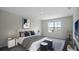 Main bedroom with large window, bed with bedding, and nightstand at 2842 Moulin Rd, Davenport, FL 33837