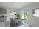 Small dining area with round table, chairs, and sliding door to backyard at 2842 Moulin Rd, Davenport, FL 33837