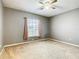 Bedroom with window, neutral walls and carpet at 308 Halstead Dr, Davenport, FL 33897