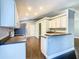 Modern kitchen with white cabinets and a breakfast bar at 308 Halstead Dr, Davenport, FL 33897
