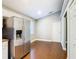 Kitchen boasts stainless steel refrigerator and wood flooring at 308 Halstead Dr, Davenport, FL 33897
