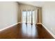 Spacious living room with hardwood floors and sliding glass doors to backyard at 308 Halstead Dr, Davenport, FL 33897