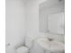 Clean and bright bathroom with white vanity, toilet and a large mirror at 3817 Giorgio Dr, Winter Haven, FL 33884