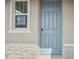 Light blue front door with simple design and white trim at 3817 Giorgio Dr, Winter Haven, FL 33884