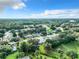 Aerial view of a community with houses and green spaces at 3904 Plantation Blvd, Leesburg, FL 34748
