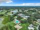 Aerial view of community amenities including clubhouse, pool, tennis courts, and golf course at 3904 Plantation Blvd, Leesburg, FL 34748