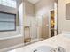 Bathroom with soaking tub, shower, and a view into bedroom at 3904 Plantation Blvd, Leesburg, FL 34748