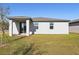 Home's backyard showcasing a patio and grassy lawn at 4702 Jasmine Cir, Leesburg, FL 34748