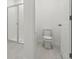 Bathroom with shower and toilet, featuring neutral-toned tile at 4702 Jasmine Cir, Leesburg, FL 34748