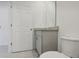 Modern bathroom with gray vanity, granite countertop, and toilet at 4702 Jasmine Cir, Leesburg, FL 34748