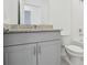 Bathroom with granite countertop and grey vanity at 4702 Jasmine Cir, Leesburg, FL 34748