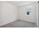 Grey carpeted bedroom with neutral walls and window at 4702 Jasmine Cir, Leesburg, FL 34748