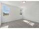 Bright bedroom featuring carpet flooring and two large windows at 4702 Jasmine Cir, Leesburg, FL 34748