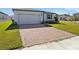 Brick paved driveway and front yard of a single-Gathering home at 4702 Jasmine Cir, Leesburg, FL 34748