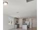 Open kitchen with gray cabinets, granite countertops, and stainless steel appliances at 4702 Jasmine Cir, Leesburg, FL 34748