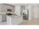 Modern kitchen with gray cabinets, granite countertops, and island at 4702 Jasmine Cir, Leesburg, FL 34748