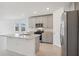 Modern kitchen with gray cabinets, granite countertops, and island at 4702 Jasmine Cir, Leesburg, FL 34748