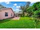 Large backyard with a grassy lawn and brick patio at 6618 Abeydon Ct, Orlando, FL 32818