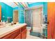Bathroom boasts teal walls, a shower/tub combo, and wood vanity at 6618 Abeydon Ct, Orlando, FL 32818