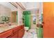 Bathroom with granite countertop, wood cabinets and a shower/tub at 6618 Abeydon Ct, Orlando, FL 32818