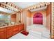 Double vanity bathroom with granite countertops and a soaking tub at 6618 Abeydon Ct, Orlando, FL 32818