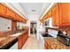 Galley kitchen with granite countertops and wood cabinets at 6618 Abeydon Ct, Orlando, FL 32818