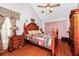 Main bedroom with hardwood floors, large bed, and ceiling fan at 6618 Abeydon Ct, Orlando, FL 32818