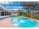 Enclosed kidney-shaped pool with a large patio at 6618 Abeydon Ct, Orlando, FL 32818