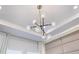 Modern chandelier with multiple lights in a bedroom at 7369 Alpine Butterfly Ln, Orlando, FL 32819