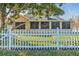 Home features a large screened enclosure and a white picket fence at 7922 Elmstone Cir, Orlando, FL 32822