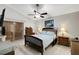 Main bedroom with a queen-size bed, wood dresser, and ceiling fan at 7922 Elmstone Cir, Orlando, FL 32822