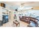 Spacious living room featuring a large leather sectional sofa and a view into the kitchen at 7922 Elmstone Cir, Orlando, FL 32822