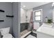 Modern bathroom with a shower, vanity and white cabinets at 857 S Atmore Cir, Deltona, FL 32725