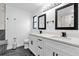 Modern bathroom with double vanity, dark tile floors and a large mirror at 857 S Atmore Cir, Deltona, FL 32725