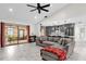 Open concept living room with gray sectional and kitchen at 857 S Atmore Cir, Deltona, FL 32725