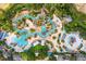 Aerial view of a resort-style pool area with water features and lounge chairs at 875 Assembly Ct, Reunion, FL 34747